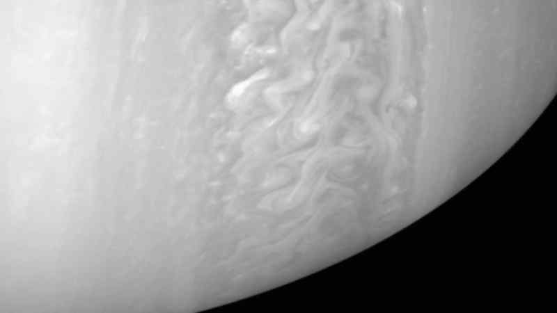 CHAOTIC BANDS OF CLOUD RACE AROUND SATURN