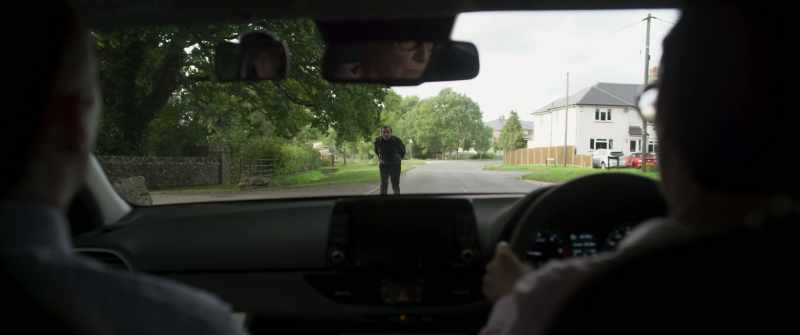 Check your mirrors and bring the car to a stop