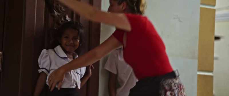 (children continue singing)