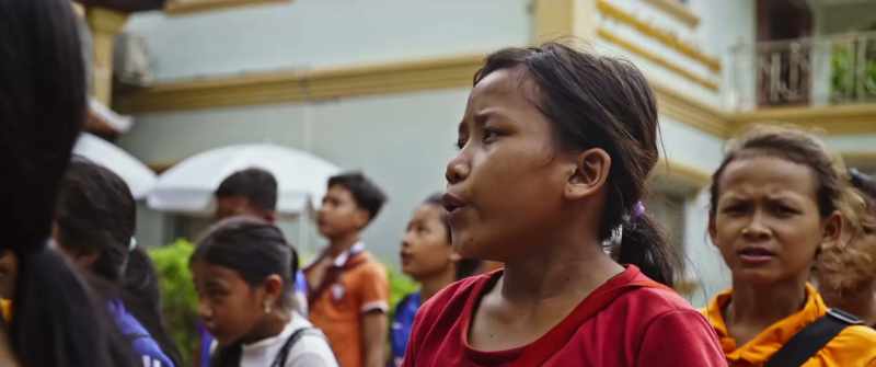 (children singing)