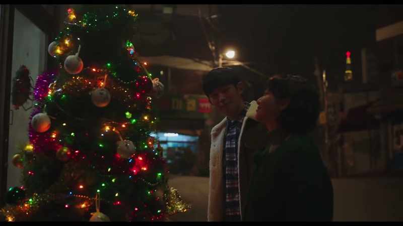 [Christmas music playing]