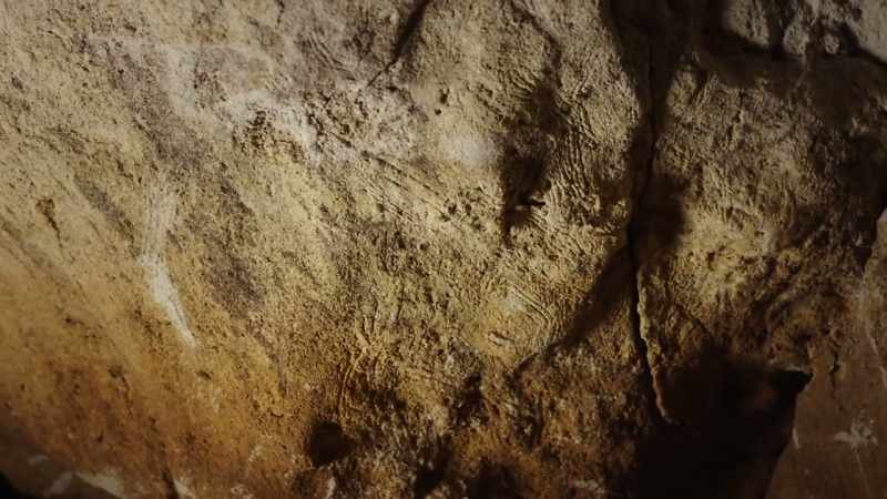 Claw scratches line the cave walls