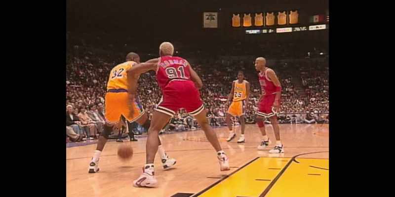 [commentator 1] Magic slaps the hand of Rodman away