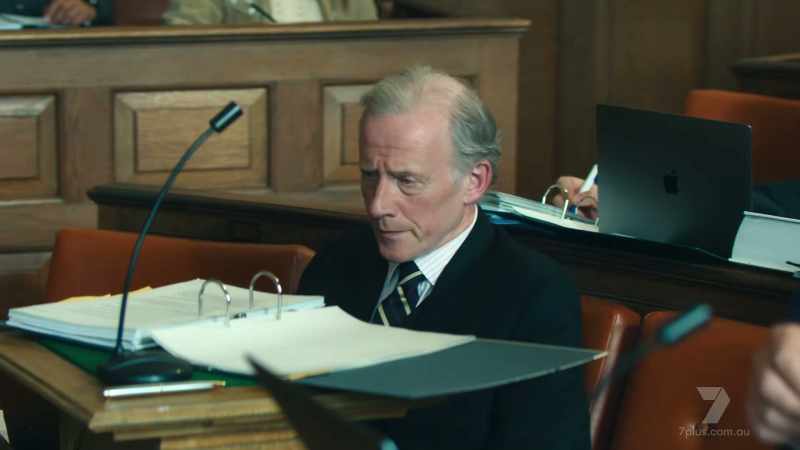 (COURTROOM MURMURS)