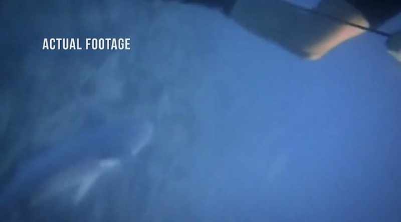 Desperate, he reaches for his dive knife