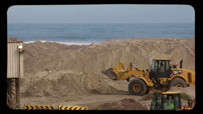 Digging up the beach, pushing the sea wall back