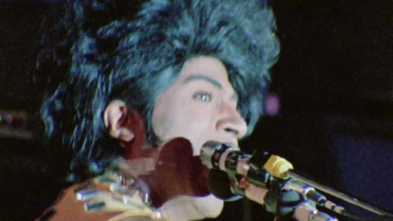 [electric guitar playing]
