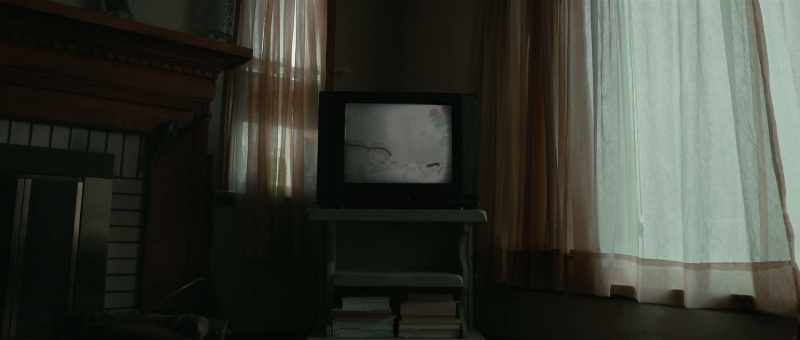 (faint chatter on television)