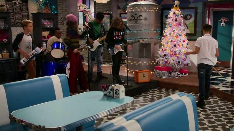 [festive rock music]