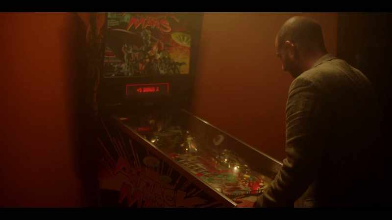 [ Flippers, pinball clacking, electronic music playing ]