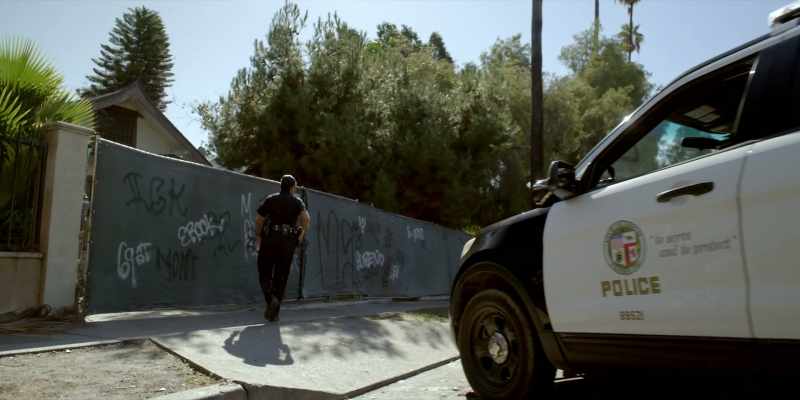Guy wearing a red and black mask running down this alley