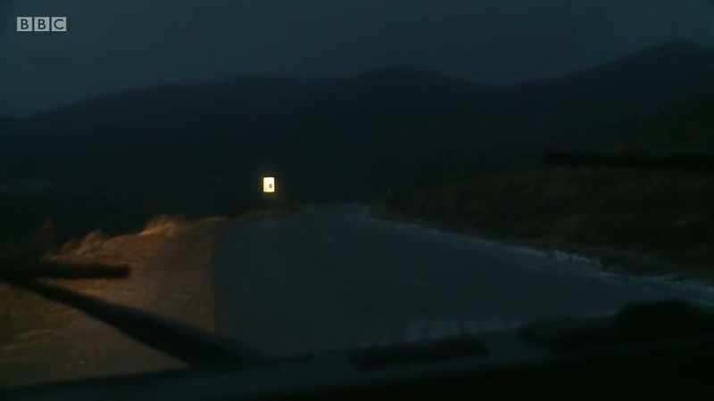 He drives back down the ice-covered road