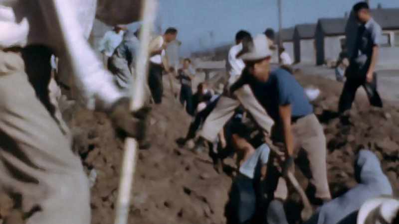 HE FILMS THE INTERNEES FORCED TO CONSTRUCT THEIR OWN PRISON