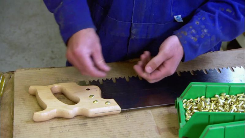 He inserts screws into the handle