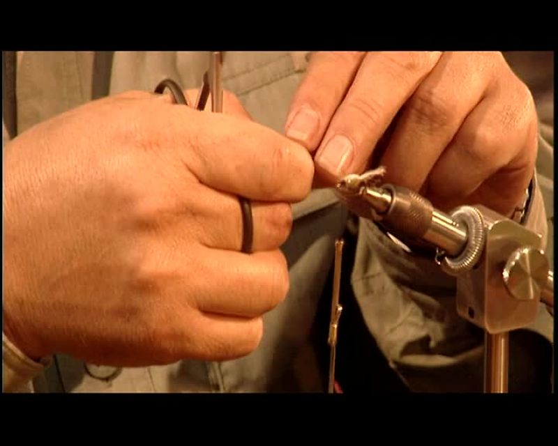 HE MEASURES THE LENGTH HE NEEDS TO CREATE THE FLY'S WINGS