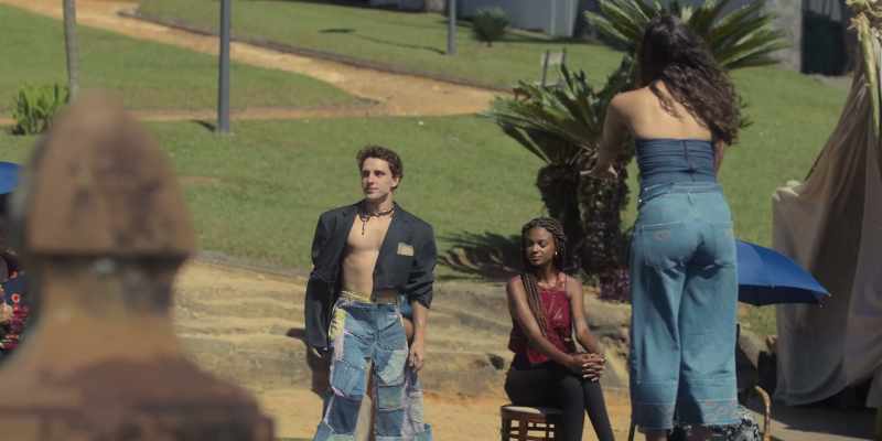 He shows off a denim skirt