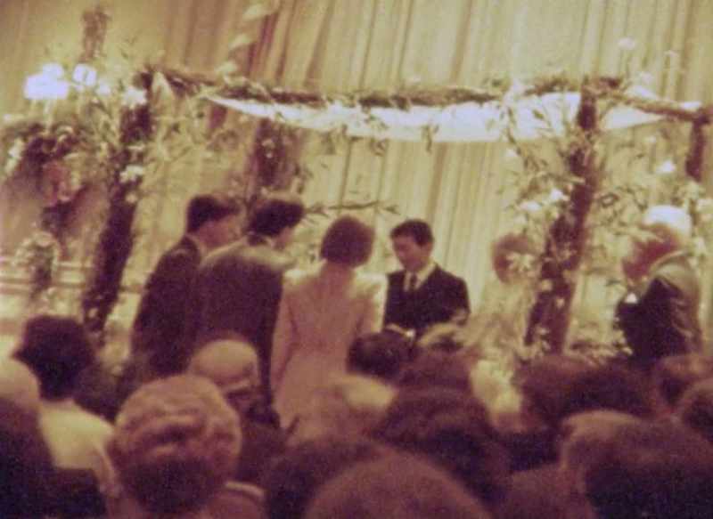 He was standing half under the chuppah and half out