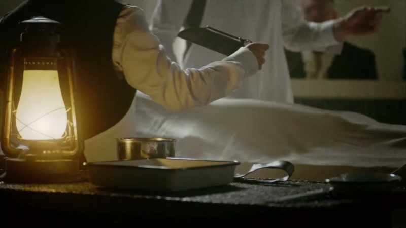 He takes his knife, holds it in his teeth