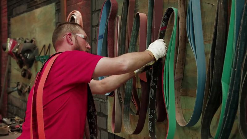 He's putting on his bandolier of belts
