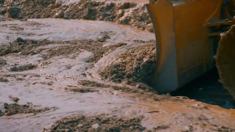 Mike pushes the watery sludge