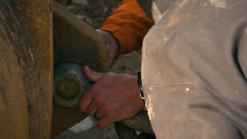 Mitch and Tyson attach lifelines to two excavators