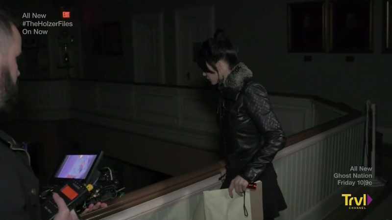 I see him wearing a suit, and he's walking around there