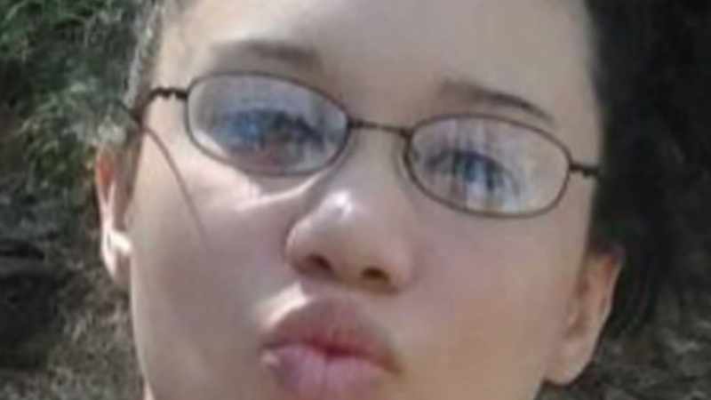 In the reflection of the eyeglasses