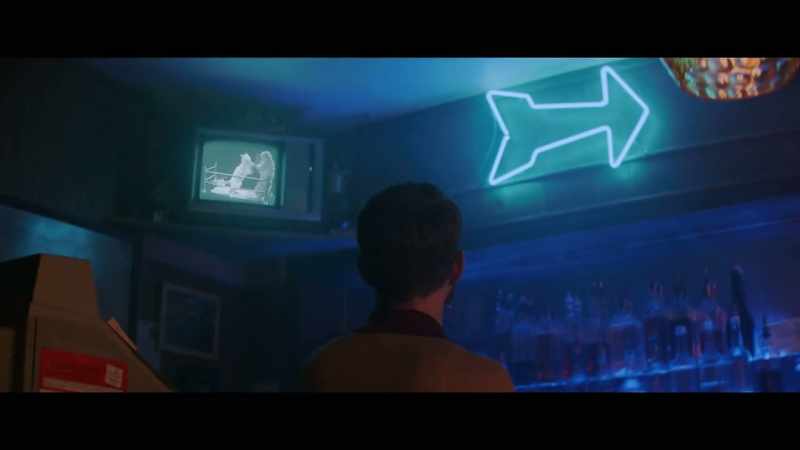 [indistinct TV chatter]