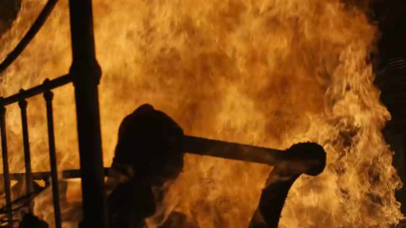 (intense orchestral music) (fire crackling)