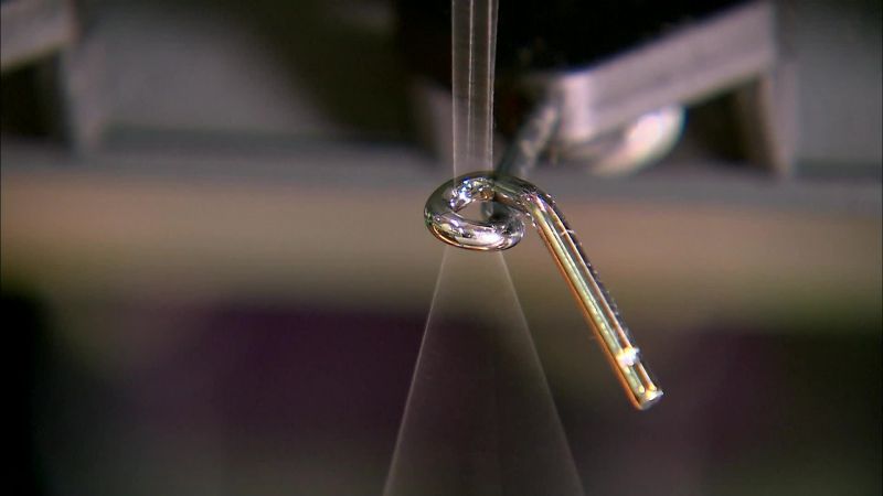 IT ACCELERATES AS THE THREADS RUN THROUGH A TENSIONING DEVICE