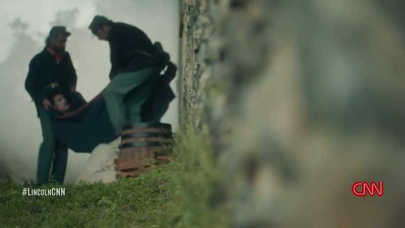 IT STRIKES A VERTEBRAE. BOOTH IS THEN DRAGGED TO THE