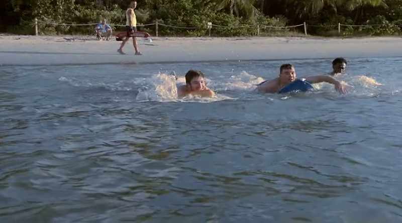 Jordon and his brother head into the surf to cool off