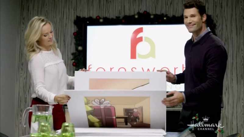 Little boy races towards the biggest gift under the tree