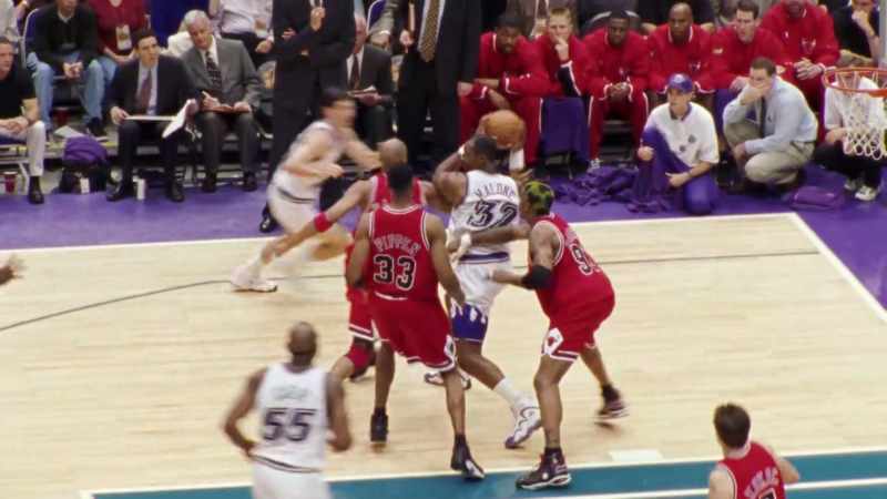Malone, three defenders on him, and they take it away