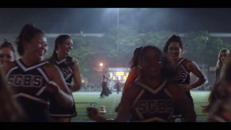 [marching band playing]
