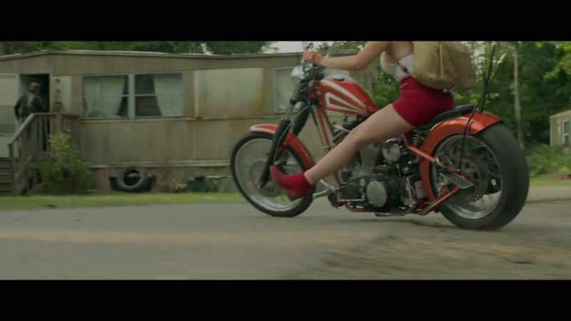 [motorcycle engine rumbling]