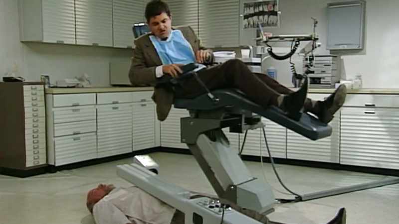 Mr Bean is in a dentist's chair and he somehow has managed to contrive