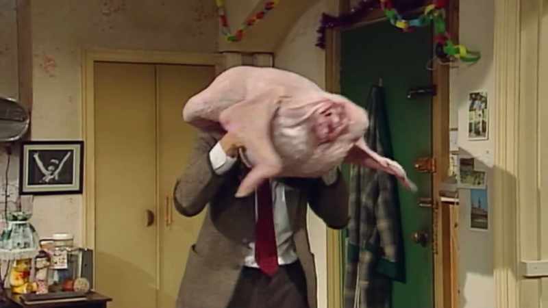 'Mr Bean walking around with a turkey on his head