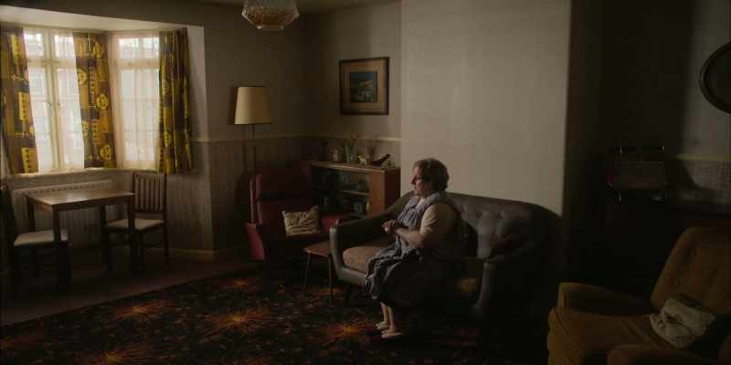 Mrs. Hodgson is sitting on the, settee