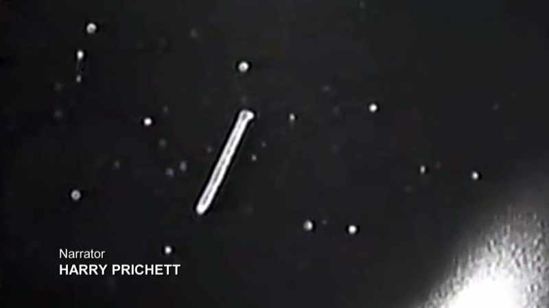 Narrator: A CAMERA RECORDS THE SATELLITE DRIFTING AWAY INTO SPACE