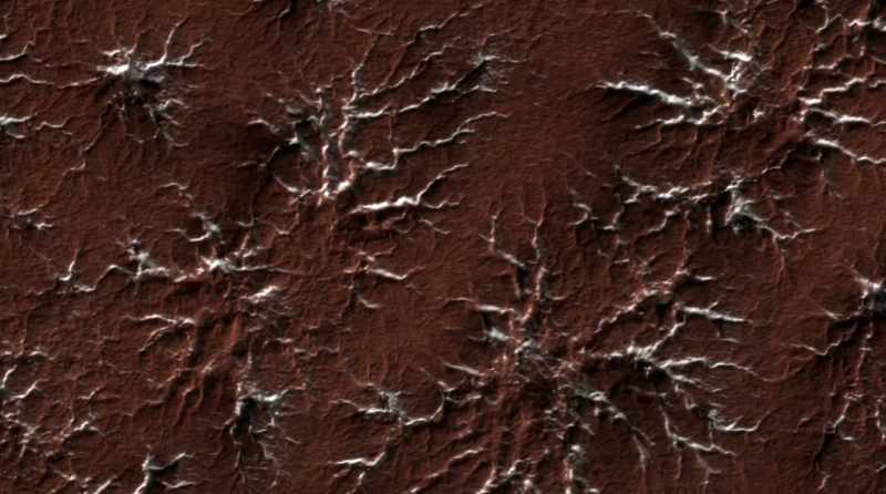 NARRATOR: Carved into the surface by exploding jets of carbon dioxide