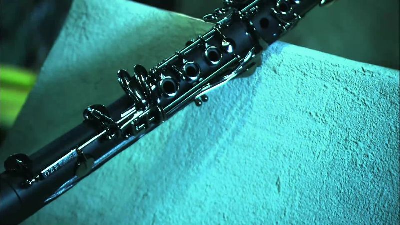 Narrator: WHEN THE CLARINETIST BLOWS INTO THE INSTRUMENT