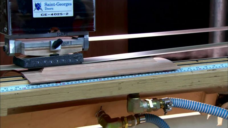NEXT, A COMPUTER-GUIDED SANDER SMOOTHES OUT THE PANEL