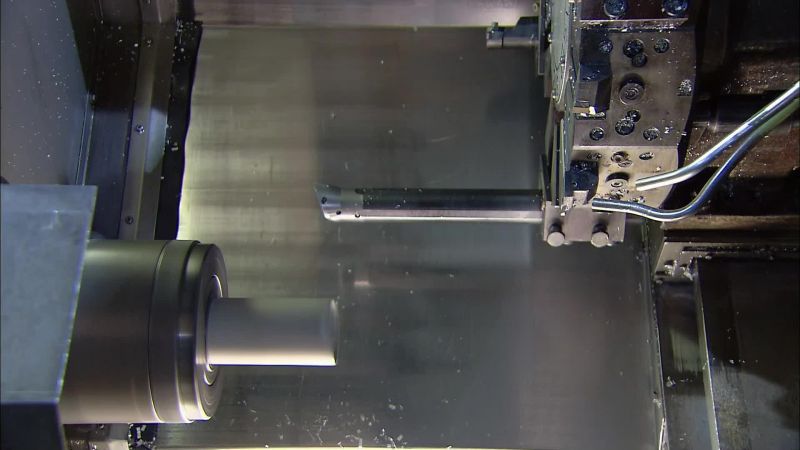 NEXT, THE BAT GOES INTO ANOTHER COMPUTERIZED LATHE