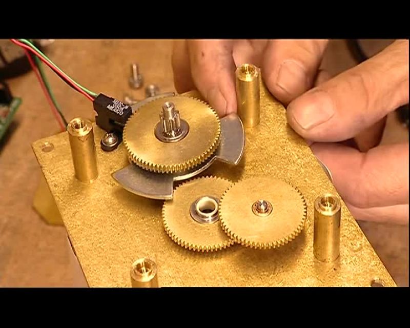 NEXT, THEY CLAMP THE STAMPER DISK INTO A TRIMMING MACHINE
