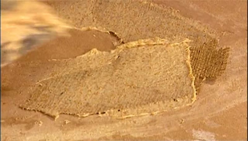 NEXT THEY SATURATE TWO PIECES OF BURLAP WITH PASTE