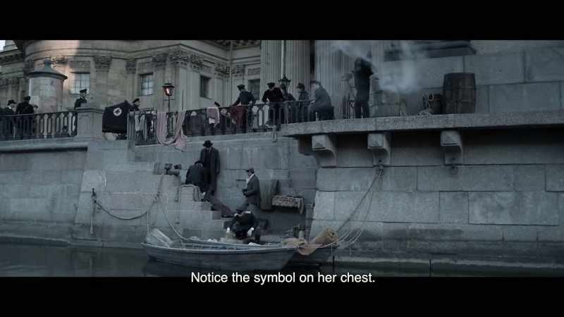 Notice the symbol on her chest