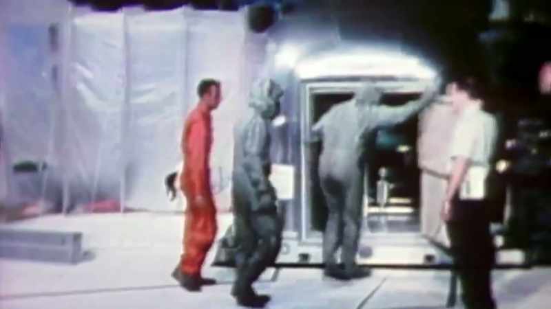 NOW THE THREE MEAN WEARING BIOLOGICAL ISOLATION GARMENTS