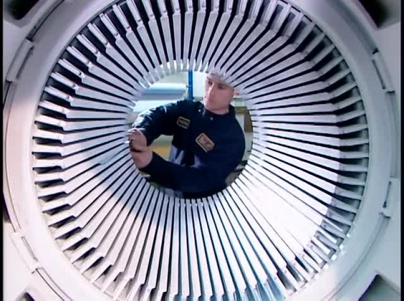 NOW WORKERS TIE THE COILS