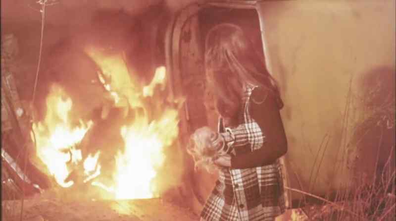 (ominous music) (flames crackling)